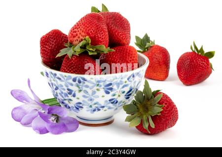 large ripe red strawberries in a pretty blue pattern bowl isolated on white Stock Photo