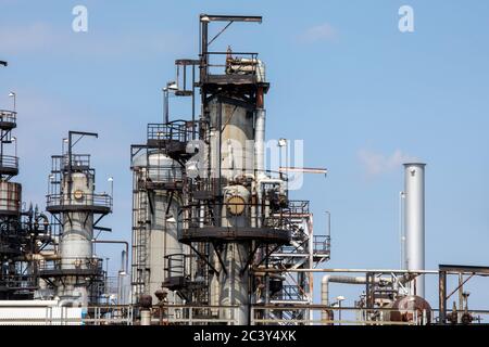 Petro chemical refinery pipes and cracking towers against a blue sky Stock Photo