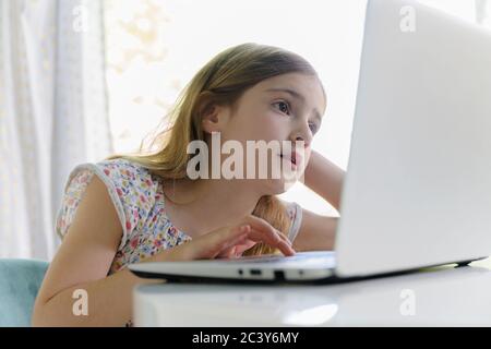 Girl (6-7) using laptop during remote learning Stock Photo