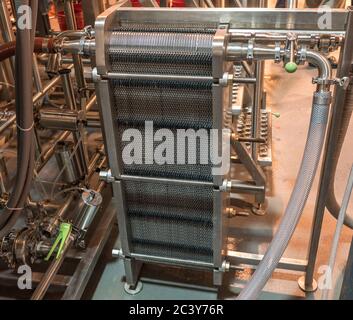 Commercial plate heat exchanger in use in a brewery Stock Photo