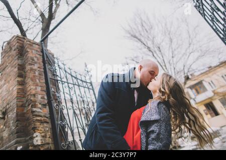 Newlywed couple kissing on street Stock Photo