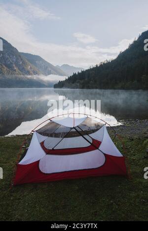 Austria, Plansee, Tent by lake Plansee at sunrise Stock Photo