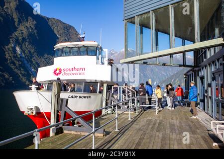 Milford Sound, Fiordland, New Zealand, June 19 2020:Tourists boarding a Southern Discoveries cruise boat again after the Underwater Observatory tour Stock Photo