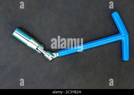 blue hinged key for spark plugs of an internal combustion engine needed at the service station Stock Photo