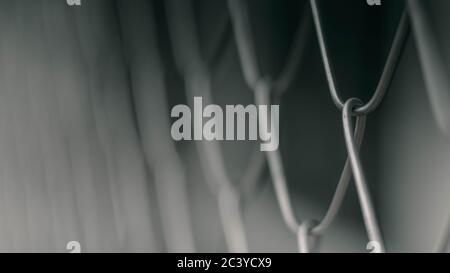 Close up Solid Metallic Wire Mesh Chain link Fence in Vintage Style Steel. Selective focus wire mesh fence Stock Photo