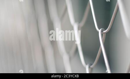 Close up Solid Metallic Wire Mesh Chain link Fence in Vintage Style Steel. Selective focus wire mesh fence Stock Photo