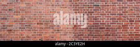 Panorama of large red brick wall with white grouting. Textured old vintage brick background. Stock Photo