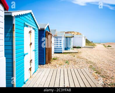 Blue beach huts and shingle Stock Photo