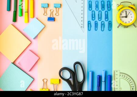 School Supplies In Frame With Colorful Paper Background. School or office stationery on colorful background. Back to School. Copy space. Stock Photo
