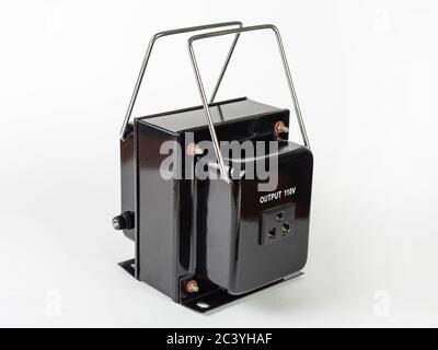110 volt black step-down transformer with stainless carrying handles on a white background Stock Photo