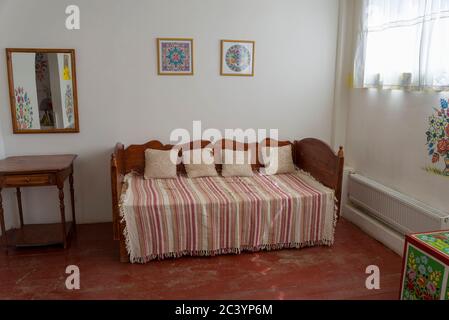 Old Belarusian bed in a residential wooden house. The concept of old decor and interior. Stock Photo