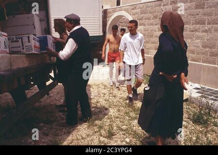 Bosnian Muslims receive aid from a British NGO who had travelled from the UK in convoy during the conflict in 1994 Stock Photo