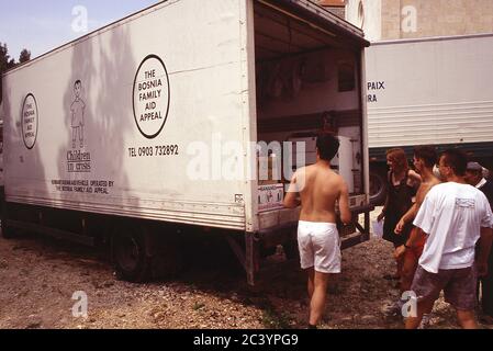 Bosnian Muslims receive aid from a British NGO who had travelled from the UK in convoy during the conflict in 1994 Stock Photo