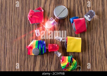 Led Series and colored insulating taper with flat batteries. Educational electronic activity for children Stock Photo