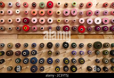 Colorful cotton thread rolls for sewing machine. thread spools for garment industry Stock Photo