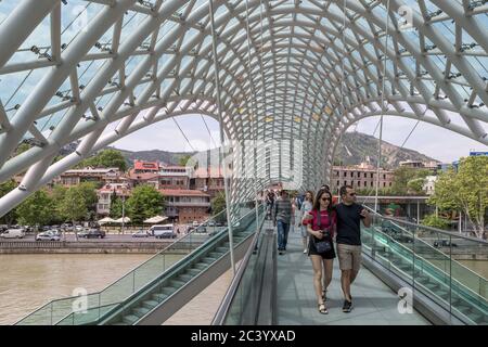 Bridge of Peace, Tbilisi, Georgia, a pedestrian bridge constructed from steel and glass construction illuminated with numerous LEDs, over the Kura Riv Stock Photo