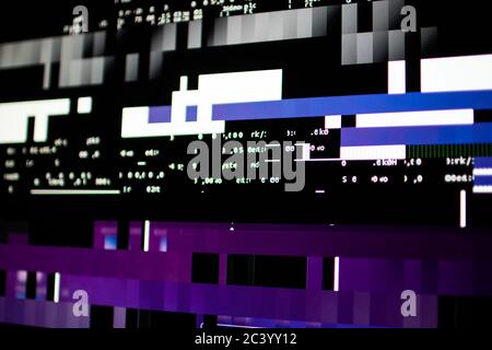 Operating system stalled after a memory overload. Presence of purple, blue and white glitches on monitor and scattered code. System and graphics card Stock Photo