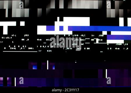 Operating system stalled after a memory overload. Presence of purple, blue and white glitches on monitor and scattered code. System and graphics card Stock Photo