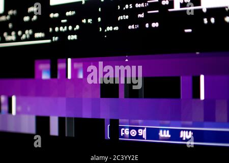 Operating system stalled after a memory overload. Presence of purple, blue and white glitches on monitor and scattered code. System and graphics card Stock Photo