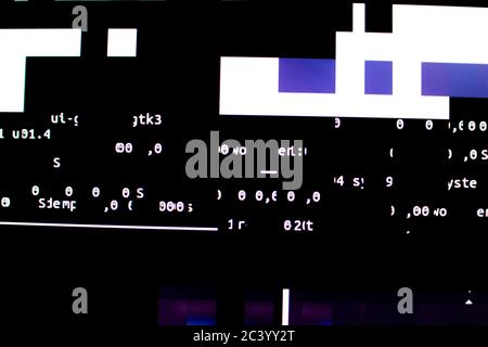 Operating system stalled after a memory overload. Presence of purple and white glitches on monitor and scattered code. System and graphics card lock Stock Photo