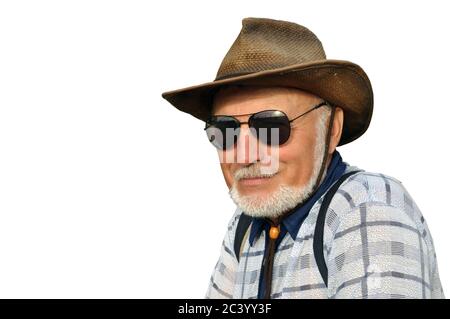 portrait of a man in hats and black sun glasses with a beard. Smiling and looking while relaxing in nature Stock Photo