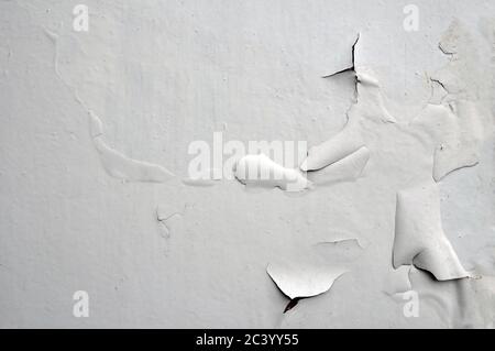 Industrial textured concrete background, white peeling paint on an old grungy wooden surface. Stock Photo