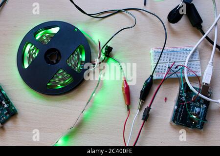 RGB led strip addressable controlled by a microcontroller open source to have green color flux. Maker project for DIY environment lighting. Lights for Stock Photo