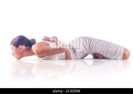 mid-adult man sitting-on mat doing yoga in-padmasana lotus pose