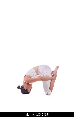 Woman practicing yoga preparing for the "  Headstand Pose ". Sirshasana Stock Photo