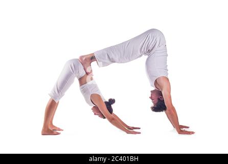 Couple practicing acro yoga against white background Stock Photo
