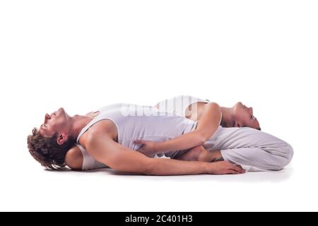 Couple practicing acro yoga against white background Stock Photo