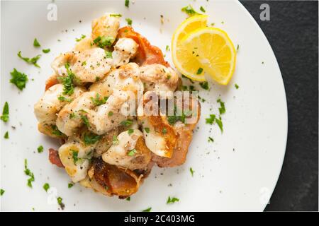Ray cheeks, also known as skate knobs, from thornback rays, Raja clavata, that have been fried with smoky bacon. Dorset England UK GB Stock Photo