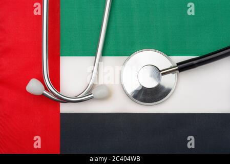 UAE flag United Arab Emirates and stethoscope. The concept of medicine. Stethoscope on the flag in the background. Stock Photo