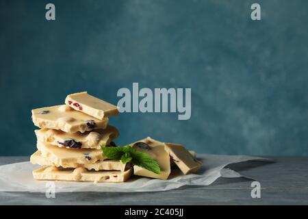 Pile of white chocolate and mint on gray wooden table Stock Photo