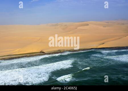 Aerial view on the shipwreck on the Sceleton coast in Namibia where dunes of the Namib desert meet with Atlantic ocean, Africa Stock Photo