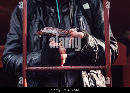 Drug addict smoking opium on tin foil, aka chasing the dragon, close up of hands with selective focus Stock Photo