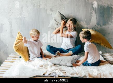.Mom with children fights pillows Stock Photo