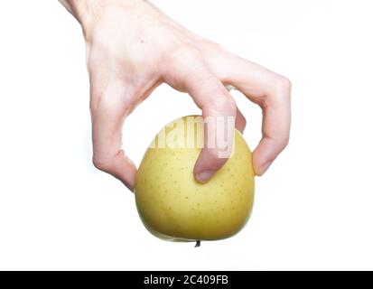 Holding an apple in the hand from below isolated on white background Stock Photo