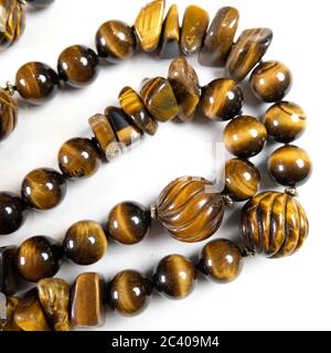 Closeup of a necklace handmade from semi-precious stones Tiger Eye Stock Photo