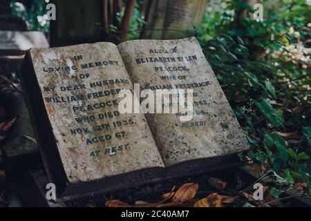 London, UK - June 16, 2020: Book-shaped tombstone for wife and husband inside Hampstead Cemetery, a historic cemetery in West Hampstead, London, opene Stock Photo