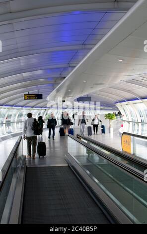 Manchester airport.  The walkway from the terminals to the railway station. People travel home, or to fly abroad. Stock Photo