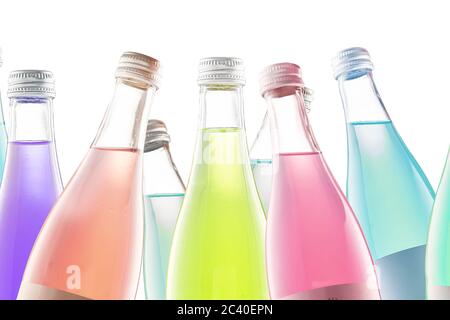 several colored colorful bottles with carbonated drinks and lemonade on a white background isolate. Stock Photo