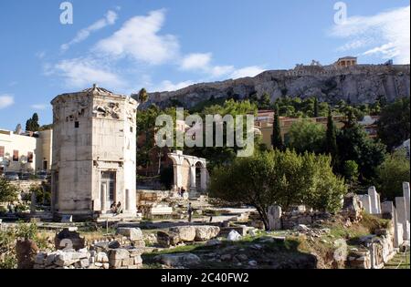 Greece, Athens the Roman Agora. The tower of the winds. In the background, the Acropolis with it’s Parthenon. Visible is the Erechtheion, a smaller te Stock Photo