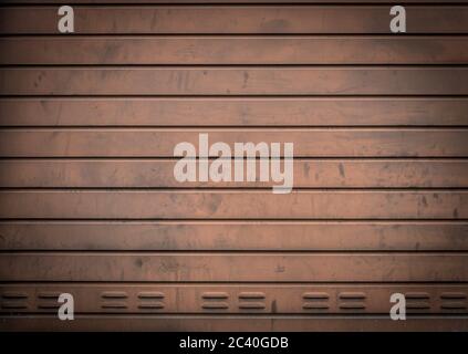 Grungy weathered metallic roll up door. Rusty iron gate. Stock Photo