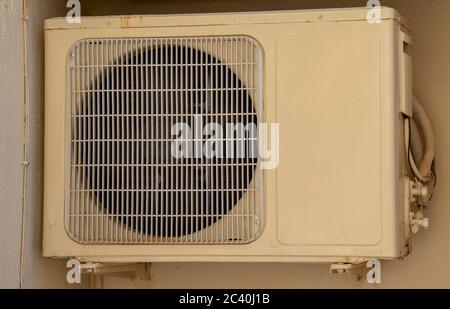 Air conditioner unit compressor outside a home. Condenser Fan for support residential cooling system. conditioning equipment machinery hanging on exte Stock Photo