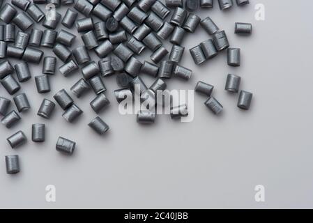 silver shiny plastic polymer granulates on white Stock Photo