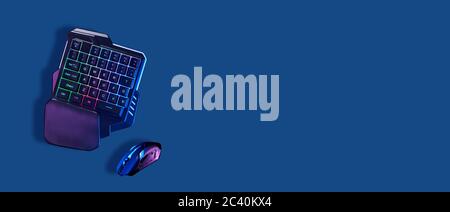 Games keyboard and mouse on blue background. Concept of games, entertainment and communication. Stock Photo