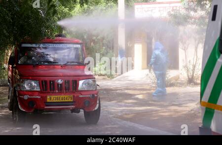 Beawar, Rajasthan, India, June 23, 2020: A municipal worker sprays disinfectant on his colleague after cremated the body of a woman who died due to the coronavirus infection, during the ongoing COVID-19 lockdown in Beawar. Credit: Sumit Saraswat/17�Թ����� Live News Stock Photo