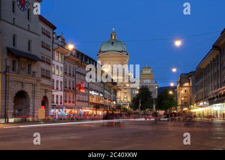 Barenplatz, with the Swiss Parliament Building looming over the square in Bern, Switzerland at night time. Stock Photo