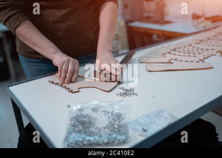 man shaping leather for shoe with knife on factory Stock Photo